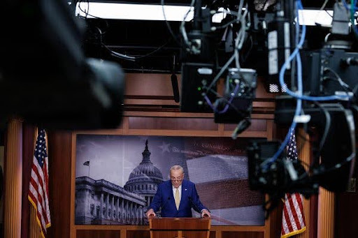 Chuck Schumer in front of a podium